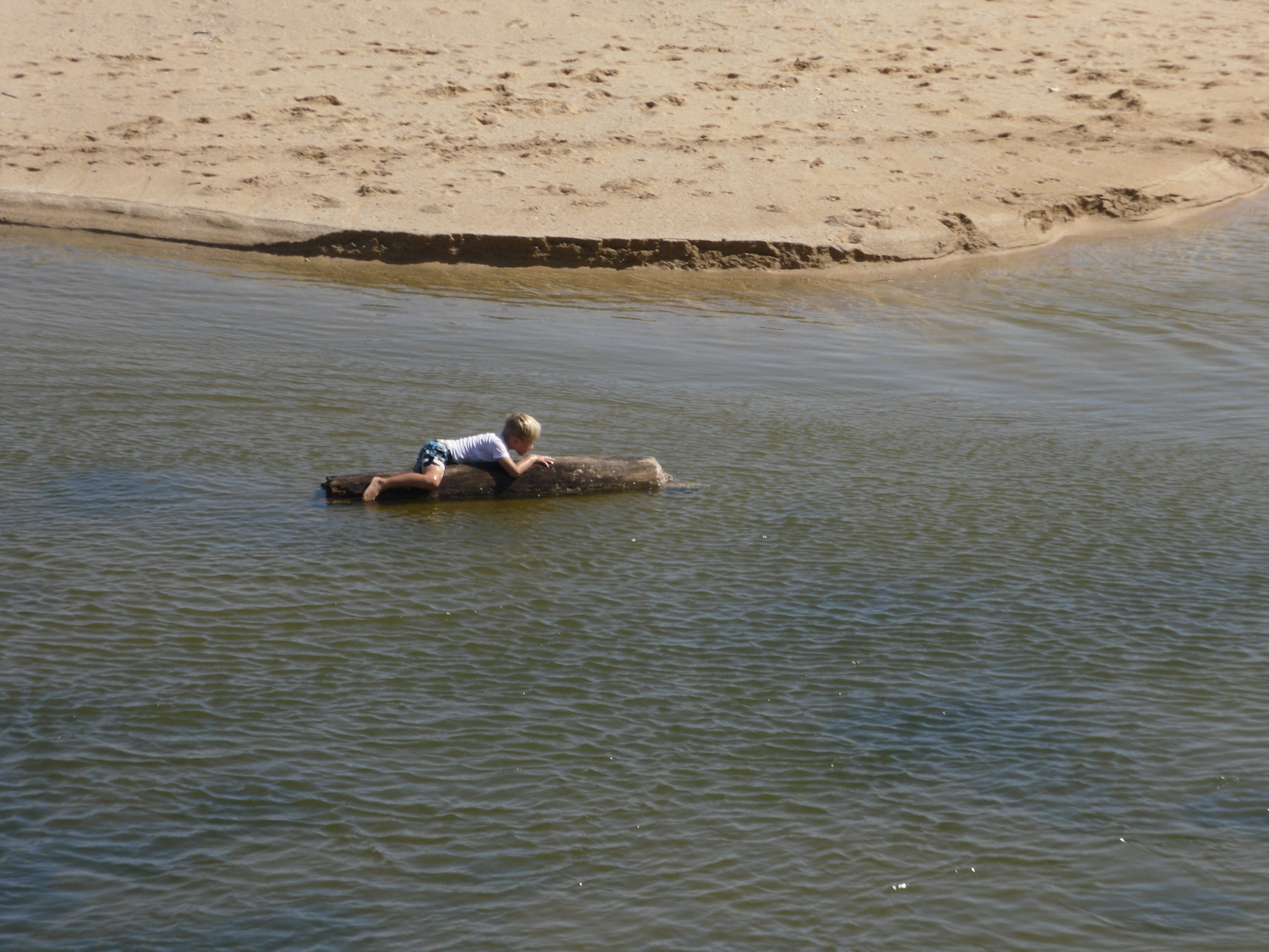 Boy floating down the Wailua River towards the ocean